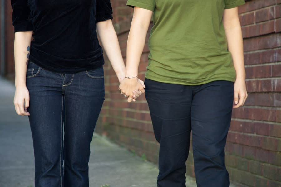 Headless couple walking holding hands