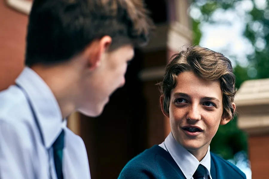 two schoolboys talking to each other