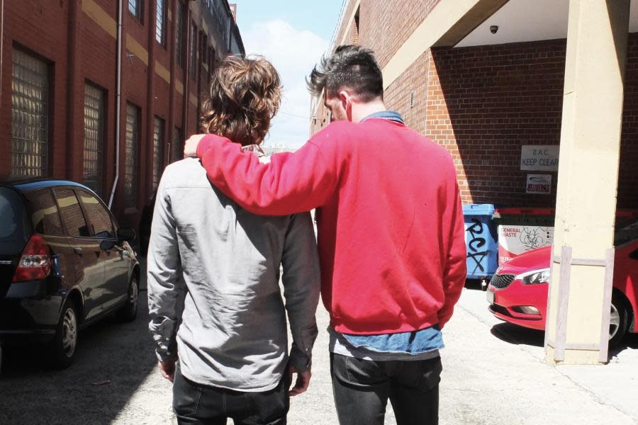 2 boys walking in alley