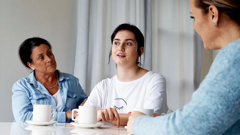 Young woman talking with parents