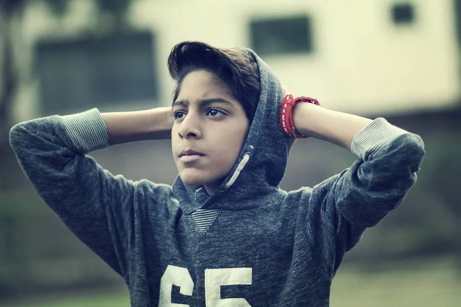 Boy in grey jumper with red watch