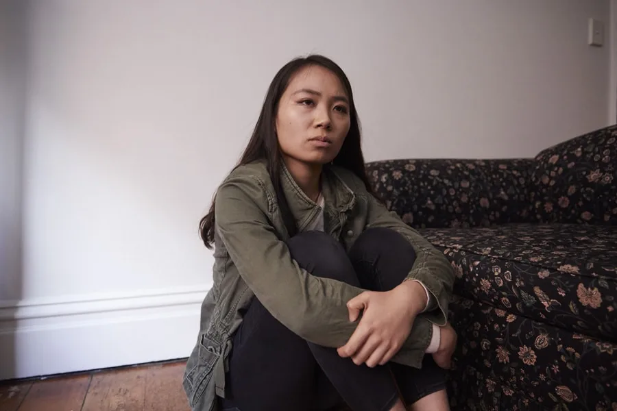 Girl depressed sitting on floor