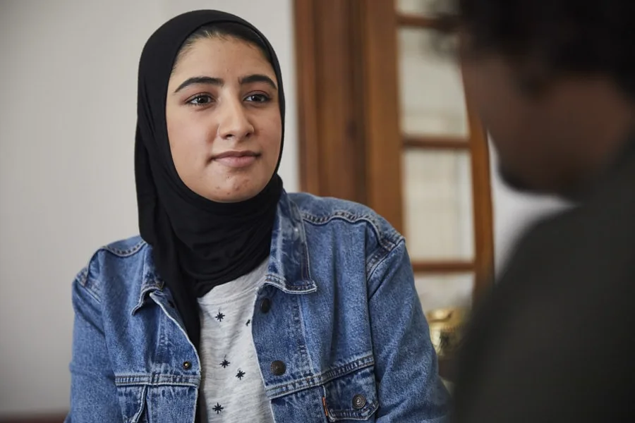 young woman speaking to friend