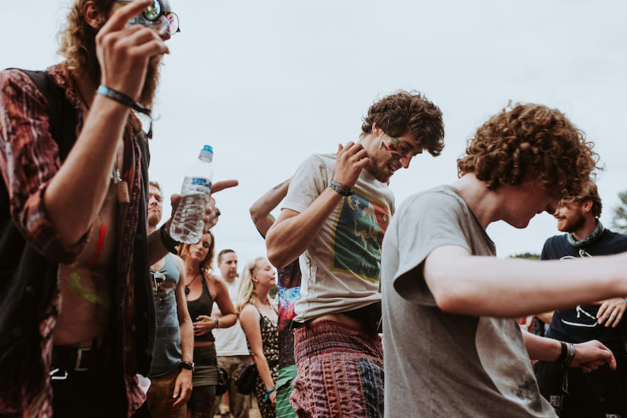 Image of teens dancing at a music festival.