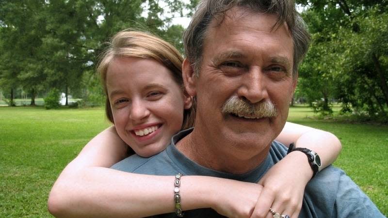 dad and daughter smiling