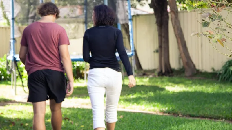 mother and son walking away