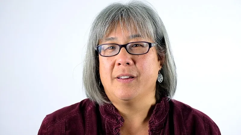 mother with glasses and maroon shirt