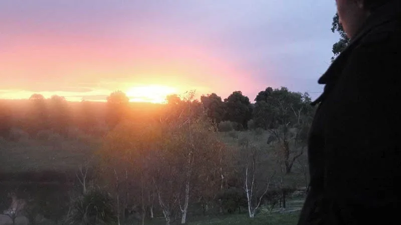 teenager looking at sunset