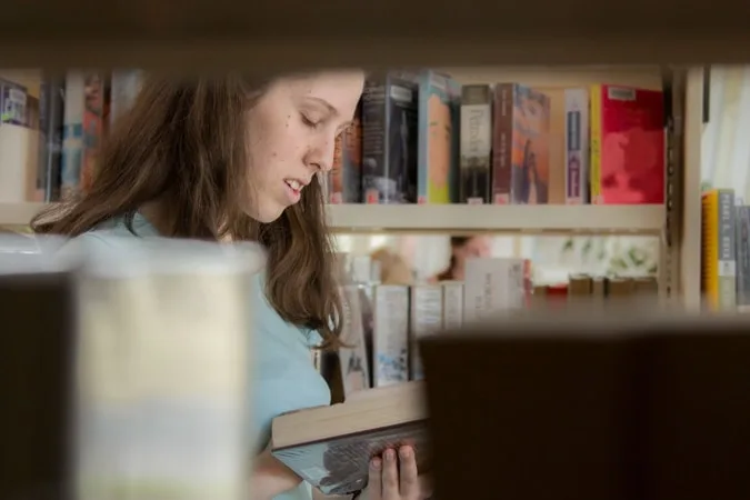 Girl reading book in a library