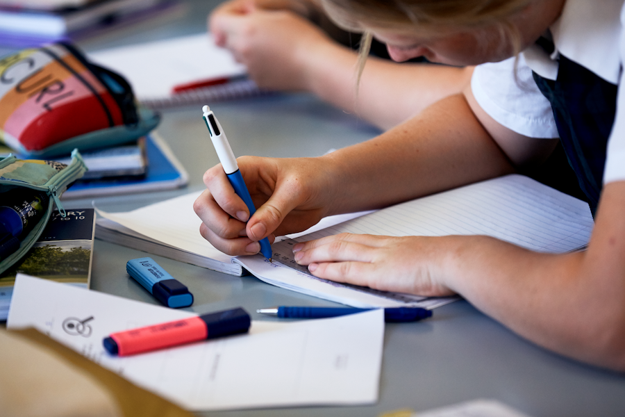 student studying with pens