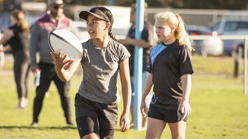 two girls playing footy