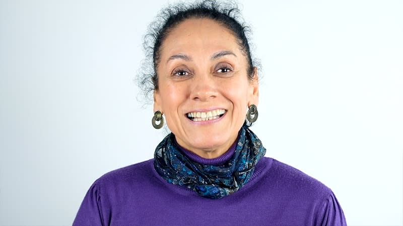 mother wearing purple shirt and scarf smiling