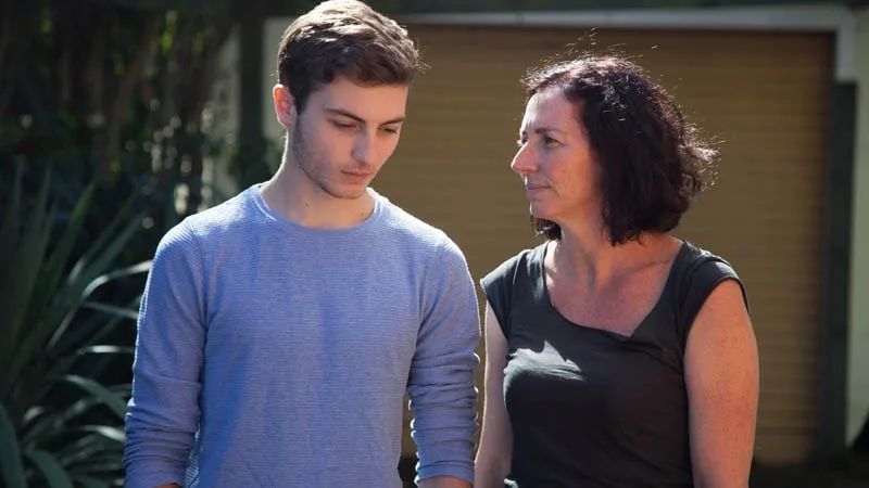 mother and son standing together