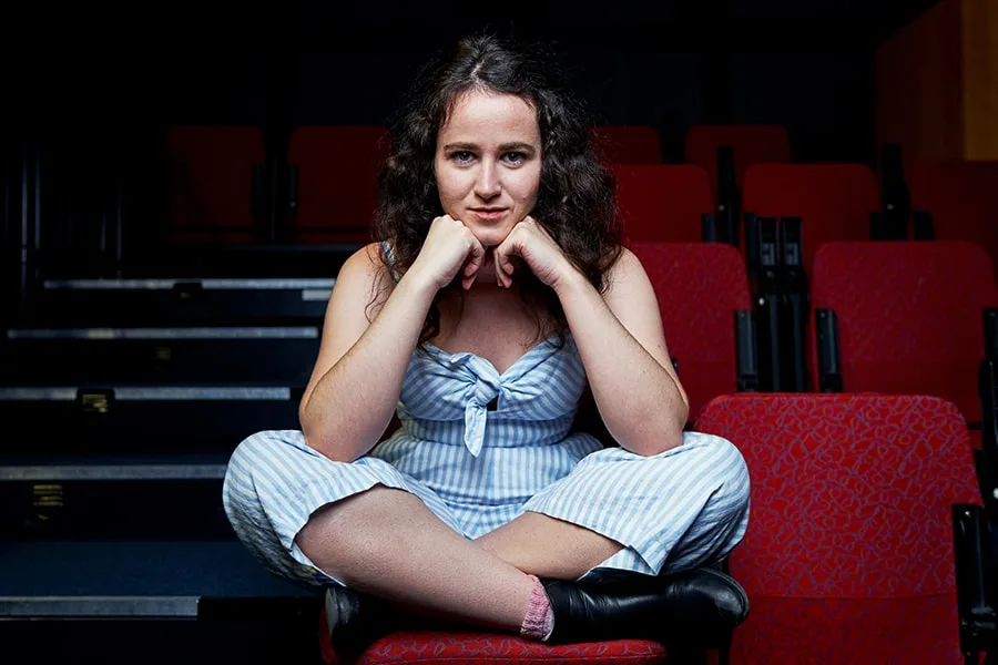 Lillianne girl sitting in empty theatre