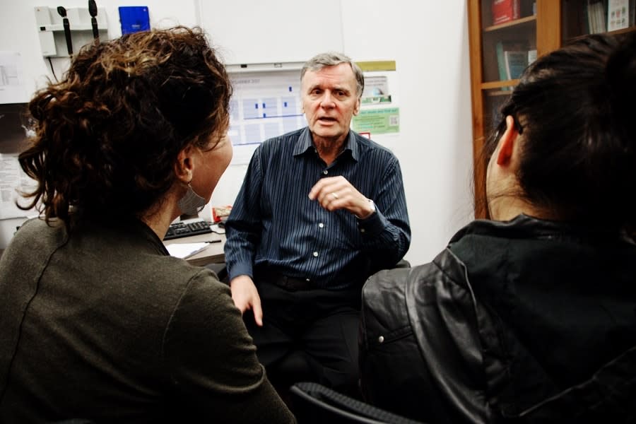 mother and daughter talking to gp in office