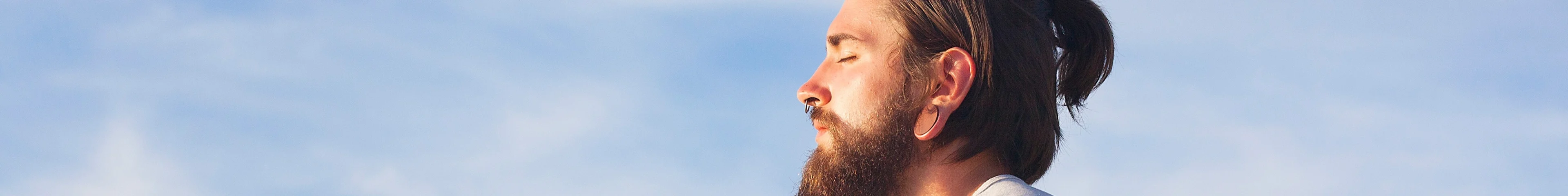 Man sitting outside in the sun meditating