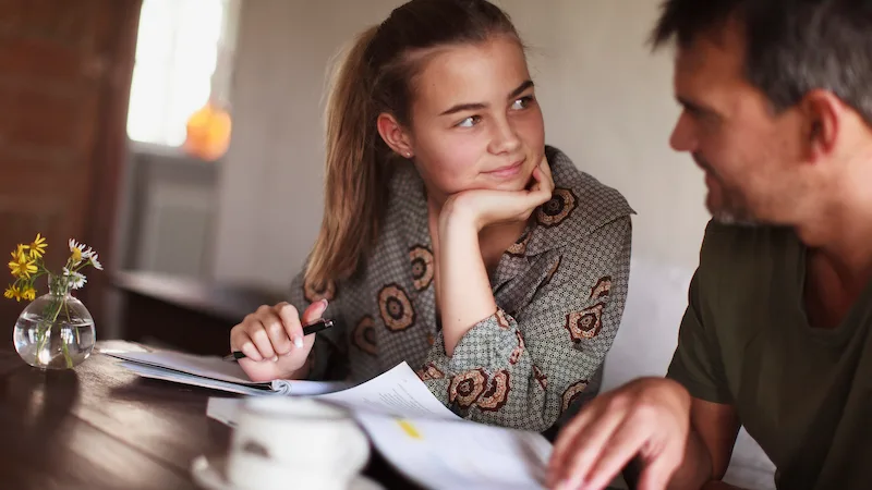 Father and daughter sitting at desk 2