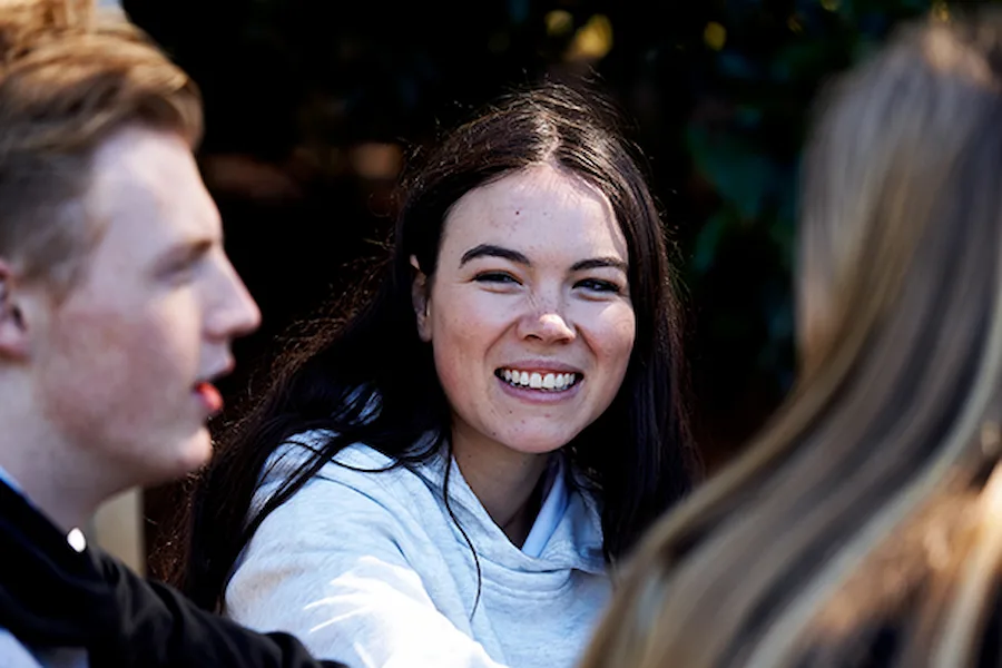 student smiling with group