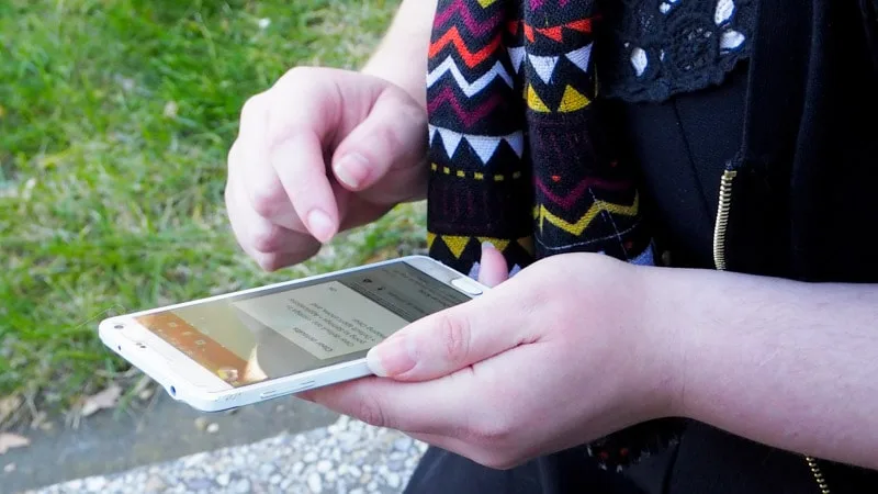 Young person changing phone settings