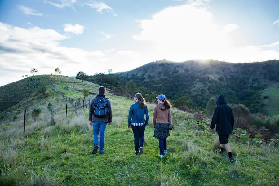 A group of young people walking outside in nature