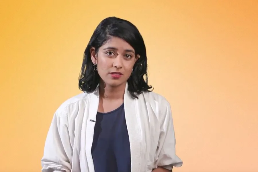 girl standing against orange background