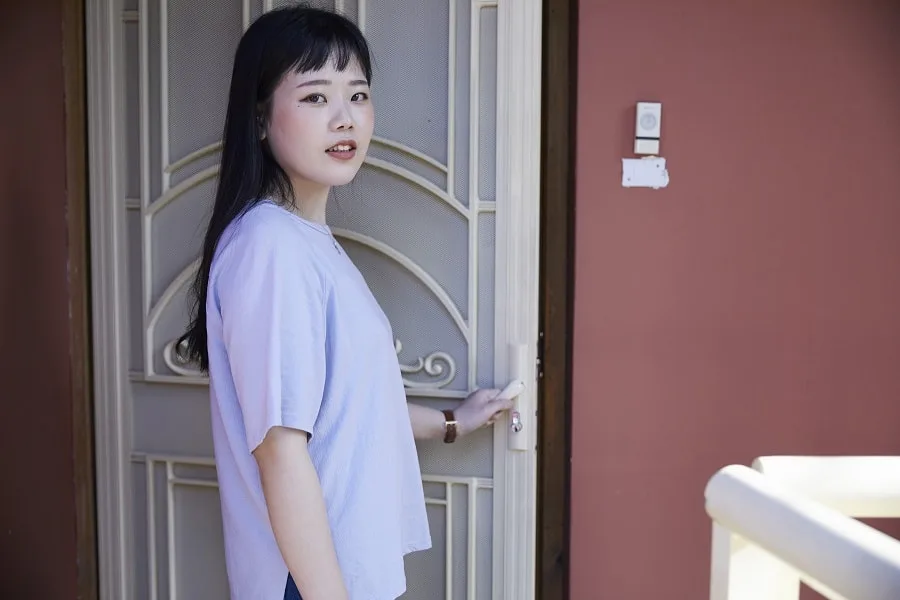 Girl in purple shirt leaving house