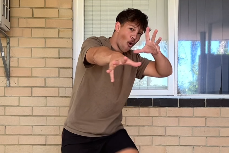 Ben Stubbs, a young Aboriginal man, dancing and looking towards the camera.