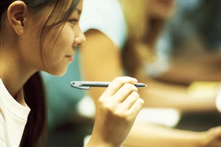 Girl holding a pen