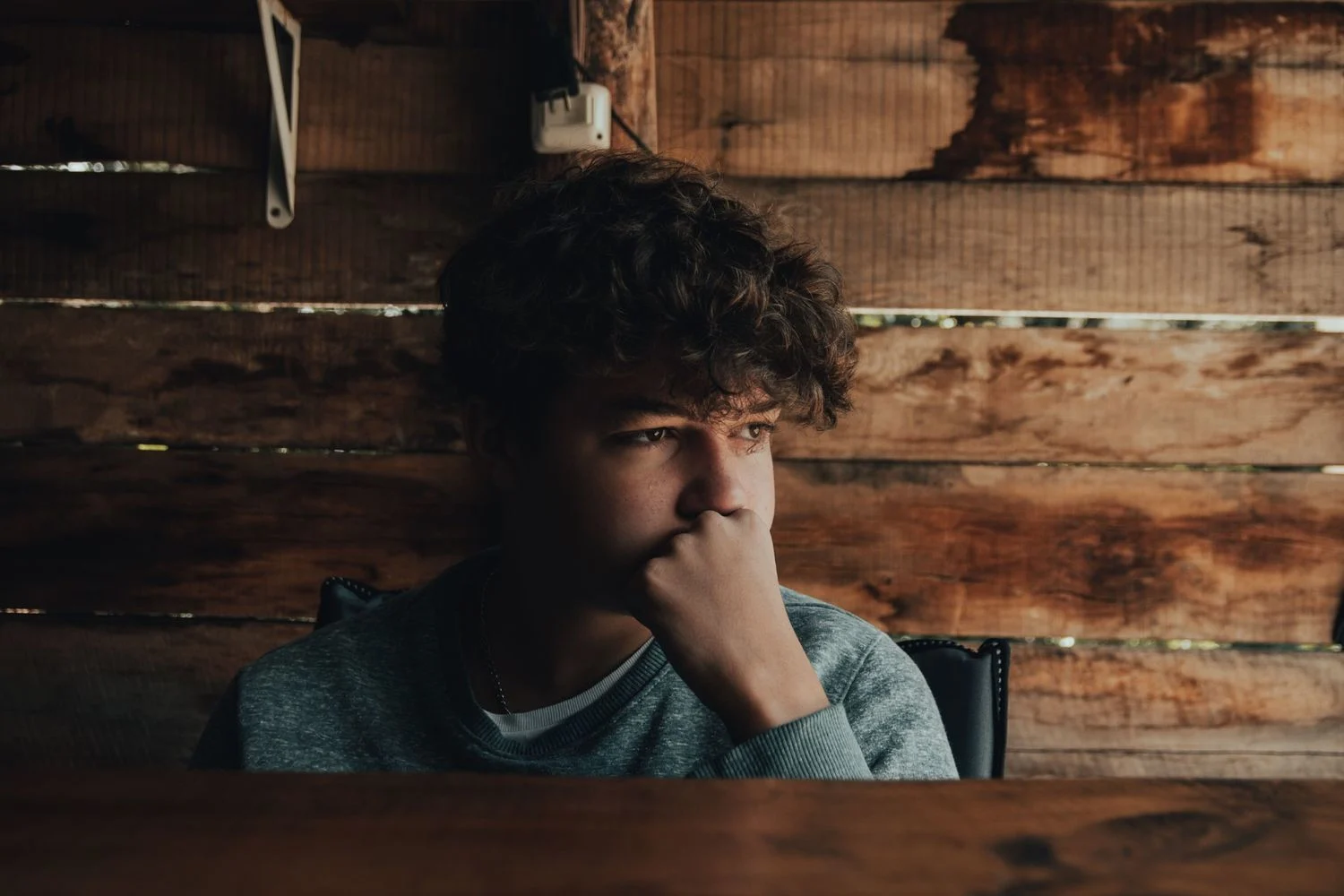 Teen boy lost in thought