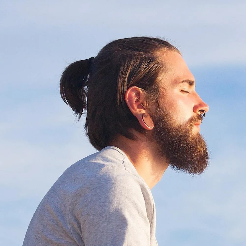 Man sitting outside in the sun meditating