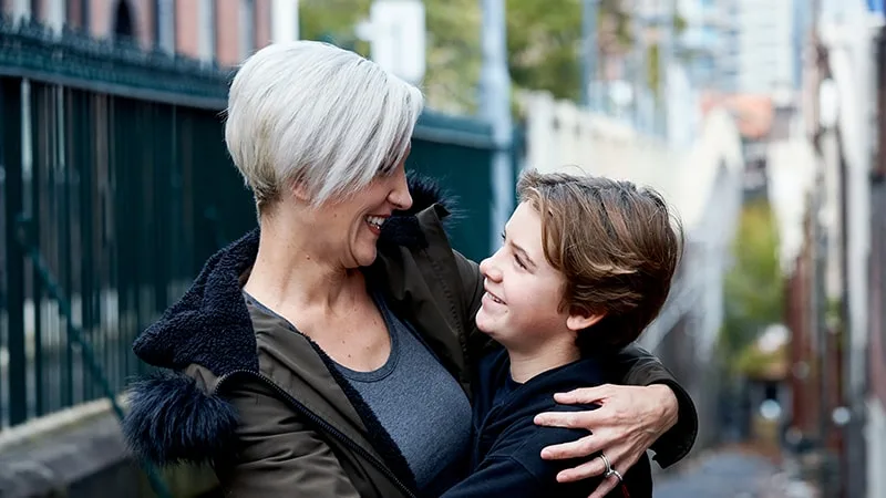 mother and son hugging and talking