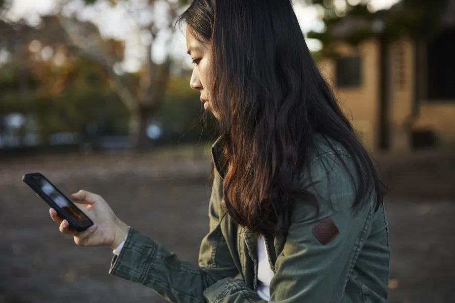 Girl in green jacket on phone