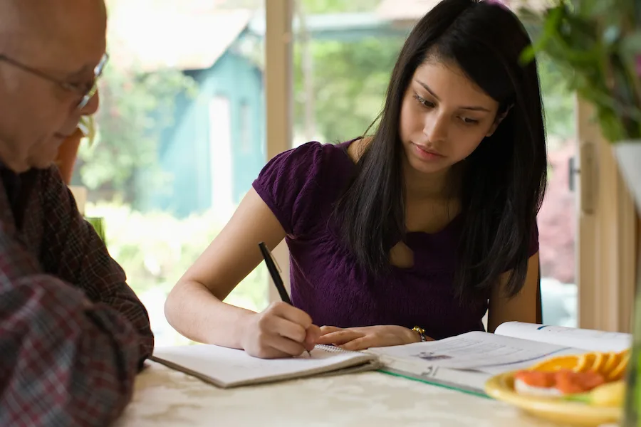 father assisting daughter with homework