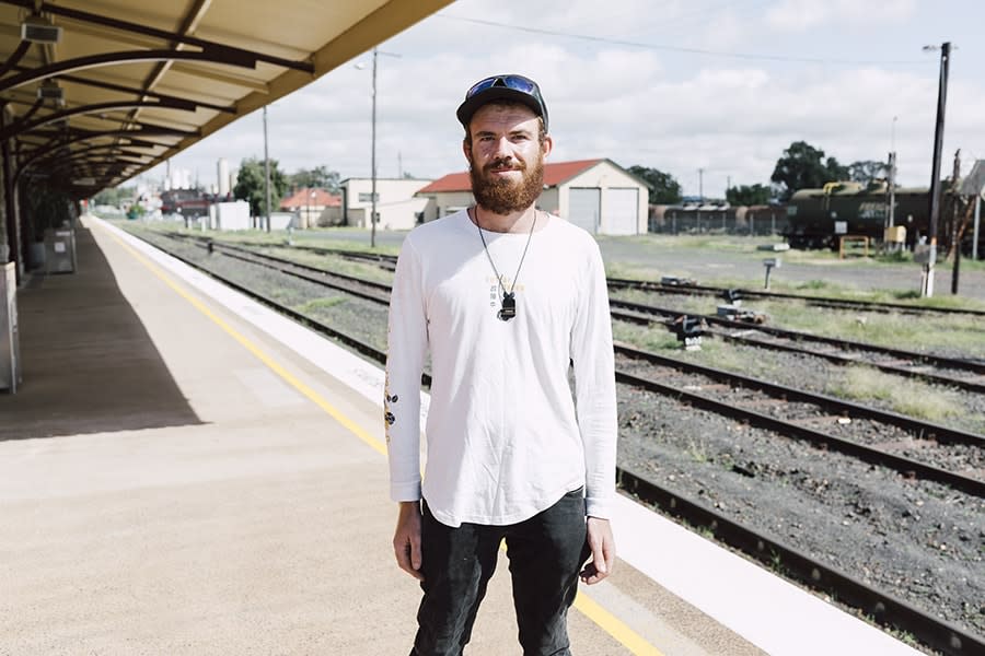 Young man standing at train station 2