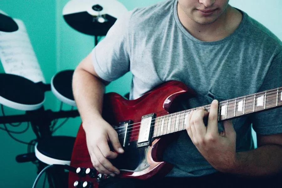 Boy playing electric guitar