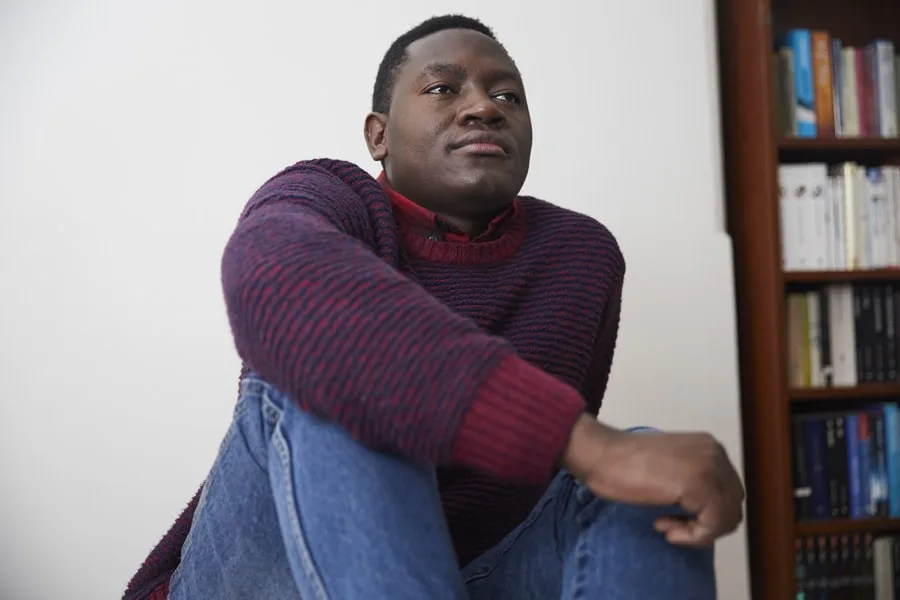 Boy looking away from camera in red sweater