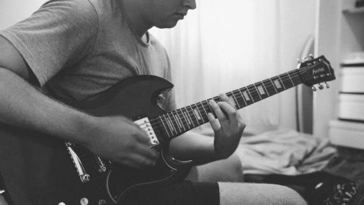 young boy playing guitar