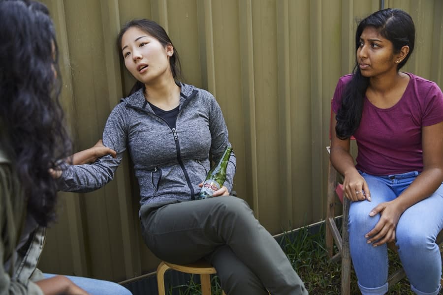 Girl tipsy talking to her two friends