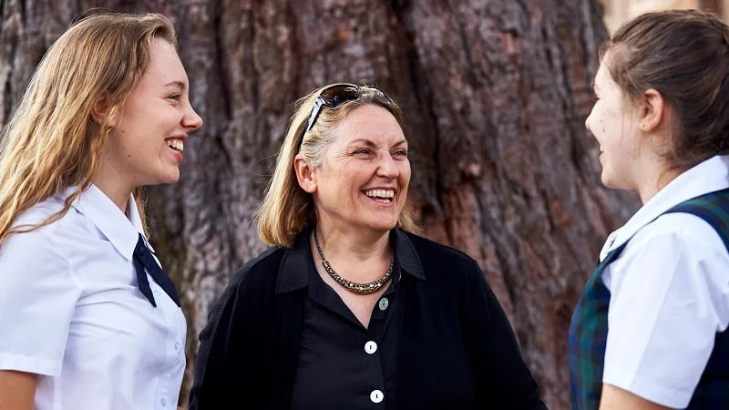 Mother and daughters smiling