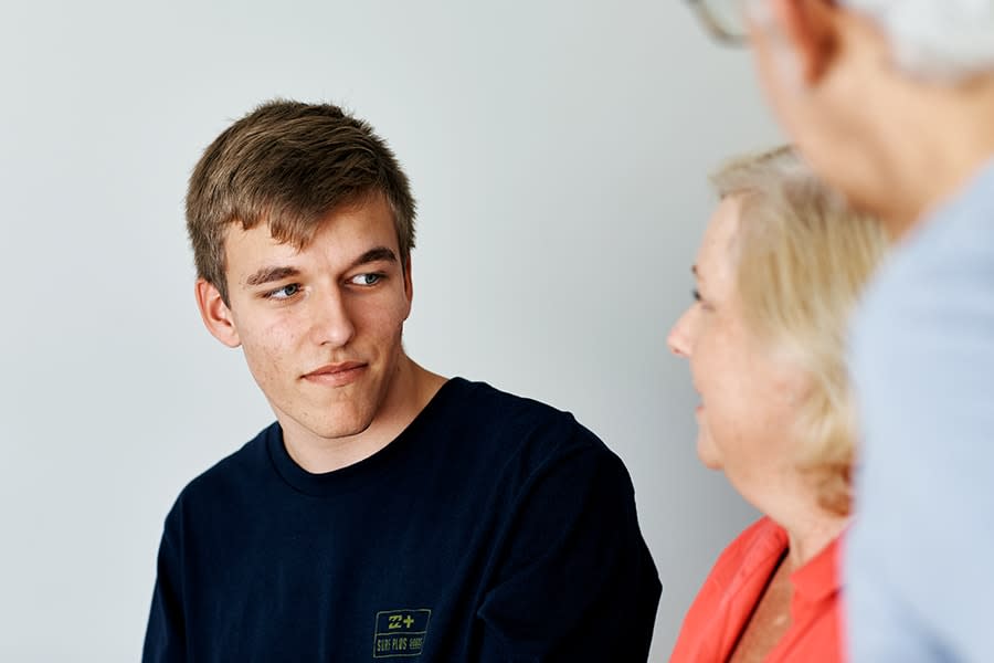 young guy talking to parents