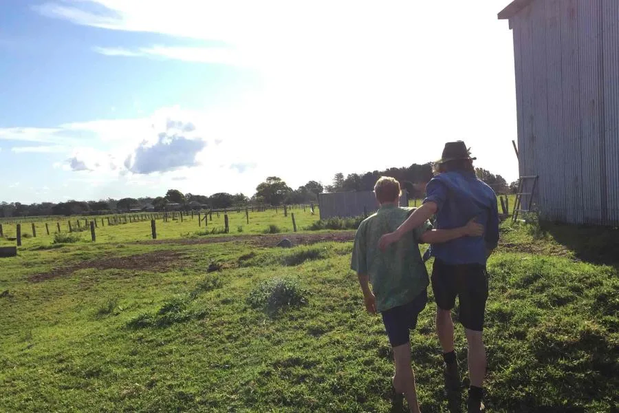 2 boys walking on farm