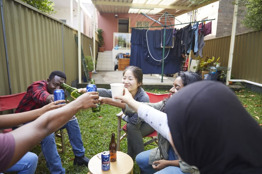 group of young people cheers drinks