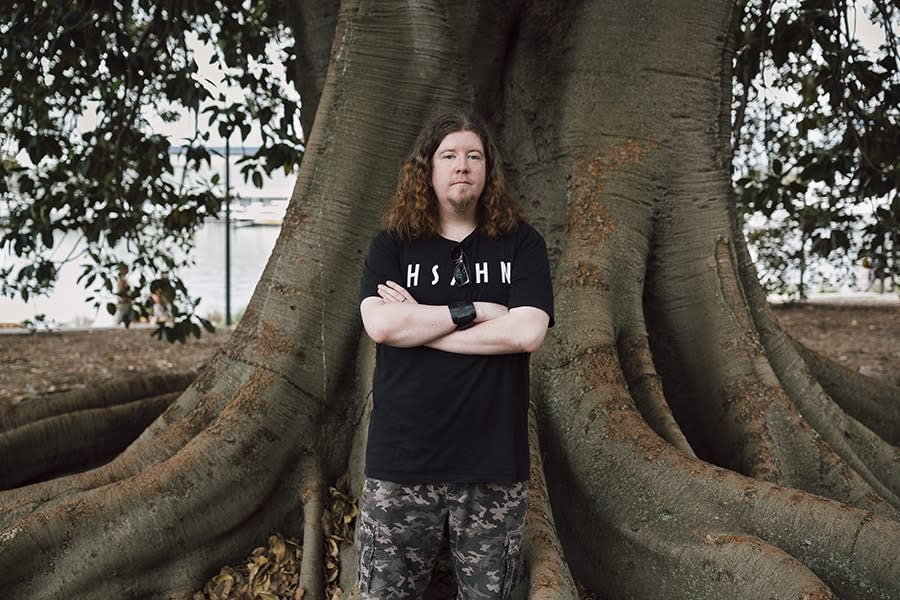 Young man standing in front of big tree 2