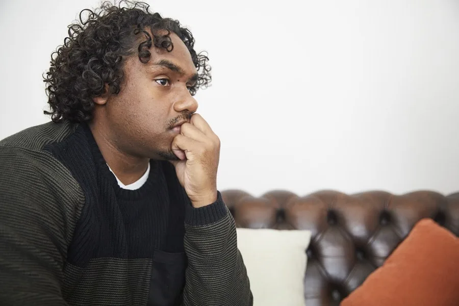 Young man in sweater looking off into the distance