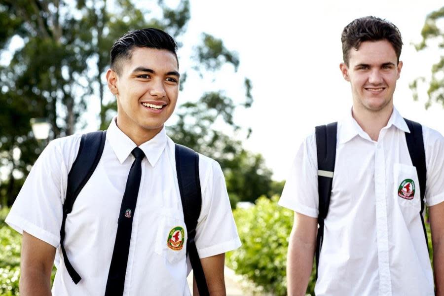 Two high school boys smiling