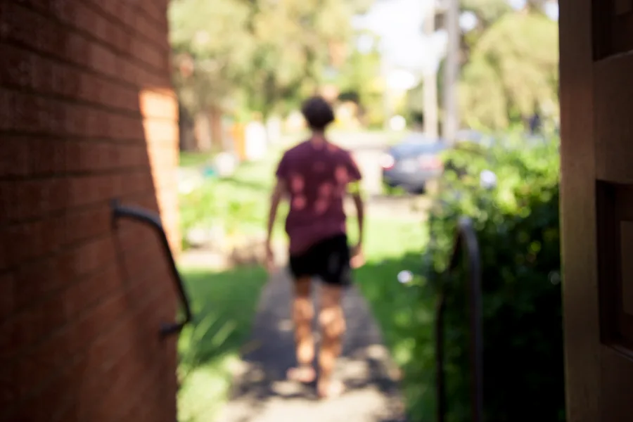 young person walking down path