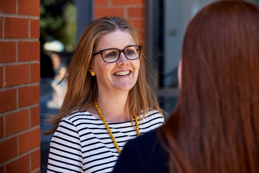 teacher looks at camera smiling