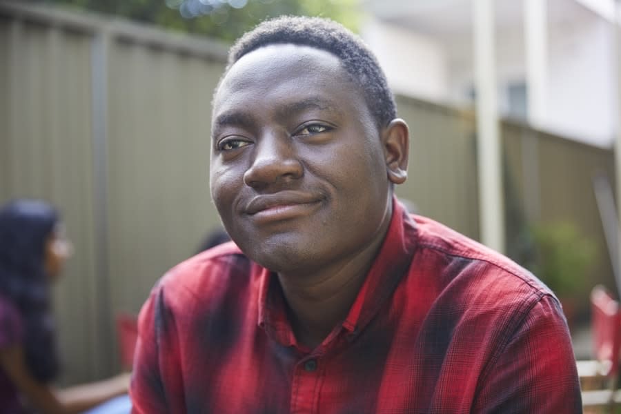 Young man in red checked shirt at party