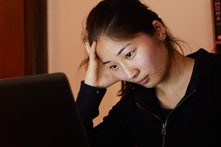 Girl in black jumper on laptop