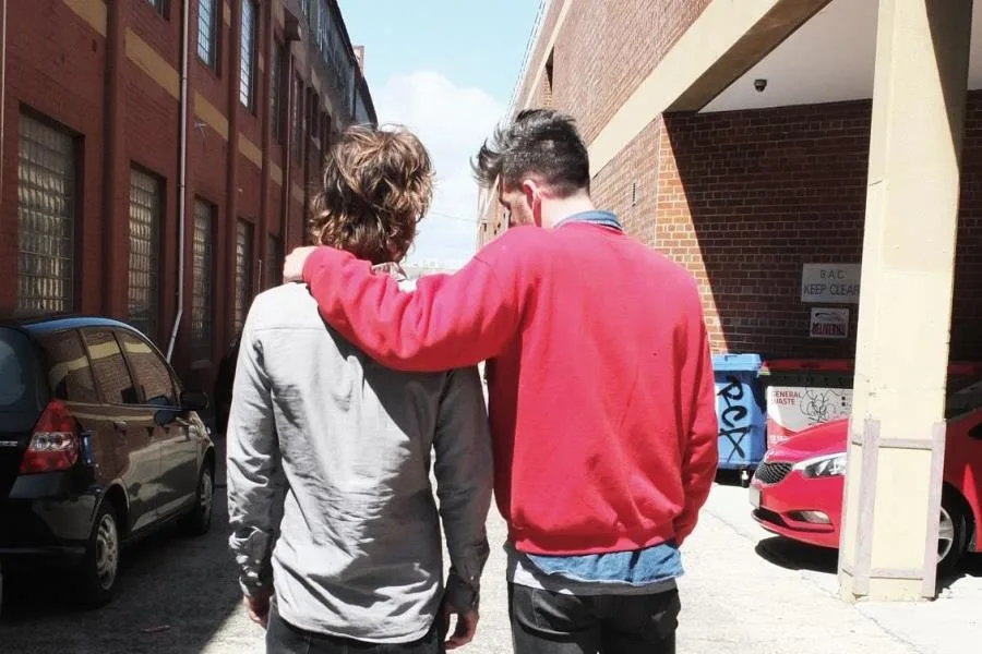 two guys walking in alley